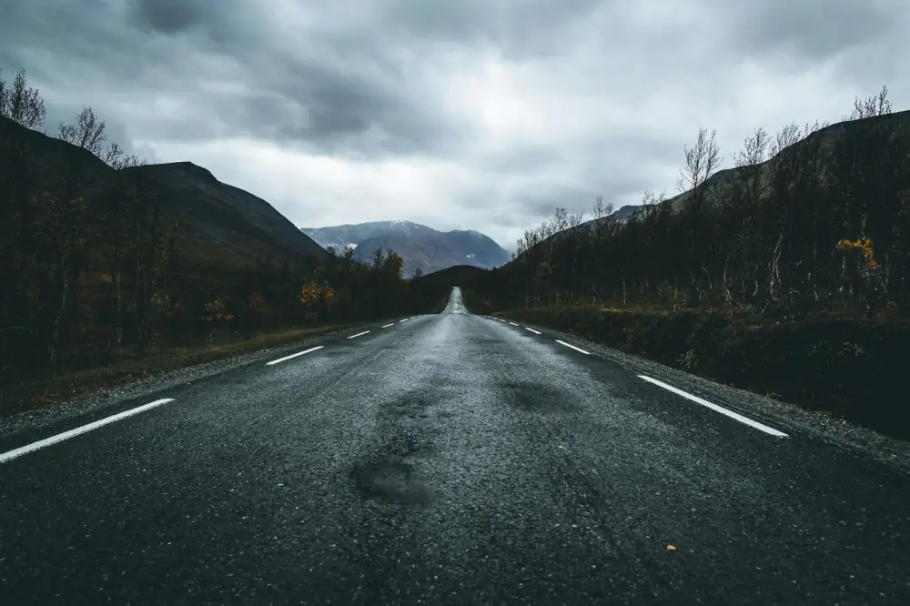 A Straight Road Leading off into the Horizon on a Cloudy Day